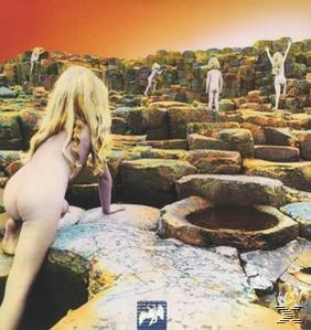 Albumcover: Nackte Figuren erklimmen felsiges Gelände, goldener Himmel.