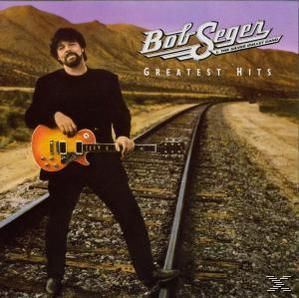 Albumcover: Bob Seger mit Gitarre auf Bahngleisen, Hügel im Hintergrund.
