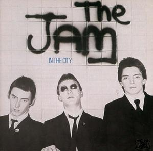 Albumcover für 'The Jam'. Drei Männer in Anzügen stehen vor einer gefliesten Wand. Schwarz und weiß.