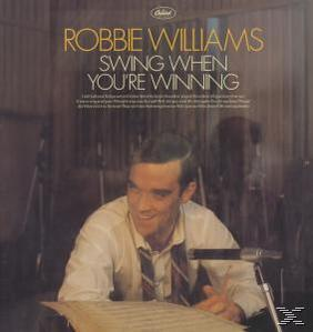 Robbie Williams Albumcover. Williams in weißem Hemd, lächelnd, mit Text: Swing When You're Winning.