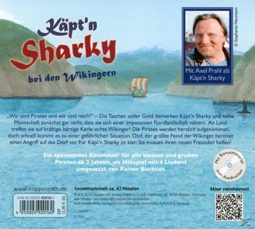 Cartoon-Cover: Käpt'n Sharky und Wikinger. Bild von Wasser, Booten und Bergen. Text mit Foto eines Mannes.
