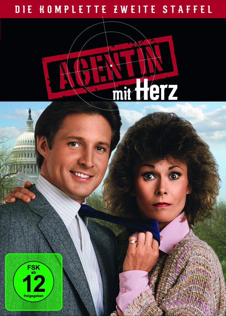 DVD-Cover: Zwei lächelnde Personen, im Hintergrund das US-Kapitol. Text: Agentin mit Herz, FSK 12.