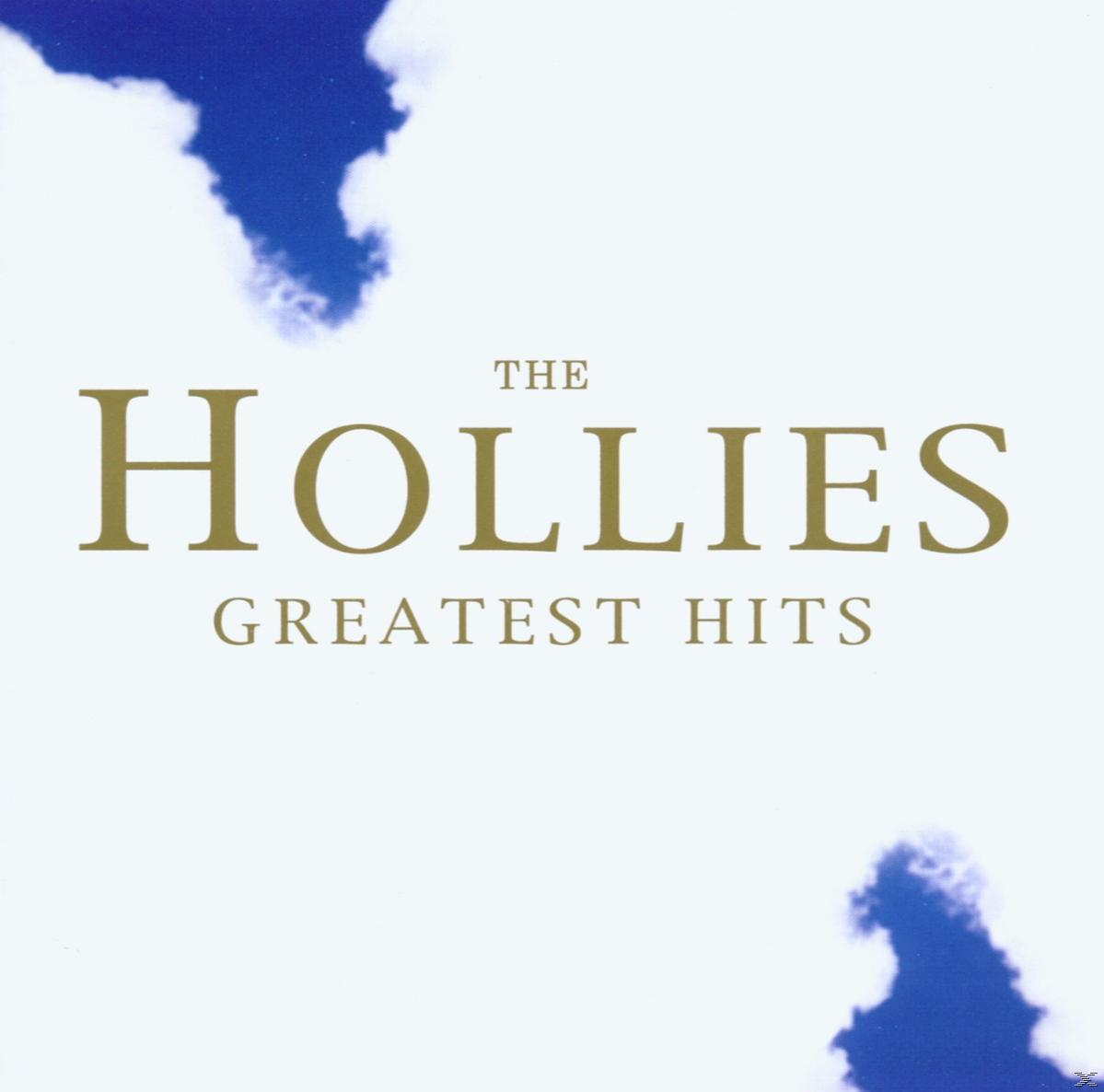 Albumcover mit dem Text 'The Hollies Greatest Hits' in goldener Schrift vor weißem Hintergrund mit blauen Wolken.