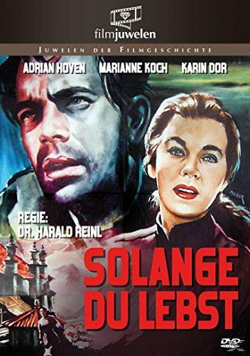 Filmplakat mit zwei Gesichtern. Mann und Frau, roter Titel 'SOLANGE DU LEBST'. Historisches Gebäude im Hintergrund.