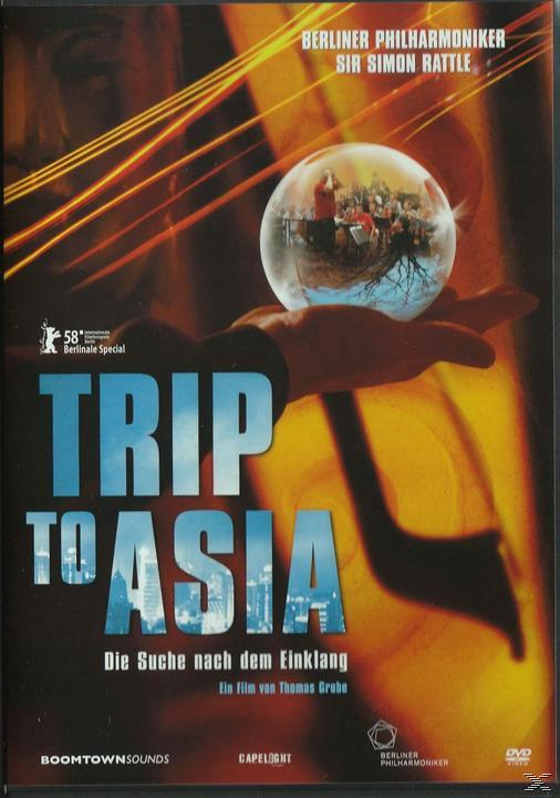 DVD-Cover: Trip to Asia. Eine Hand hält eine Weltkugel mit Menschen darin. Film von Thomas Grube.