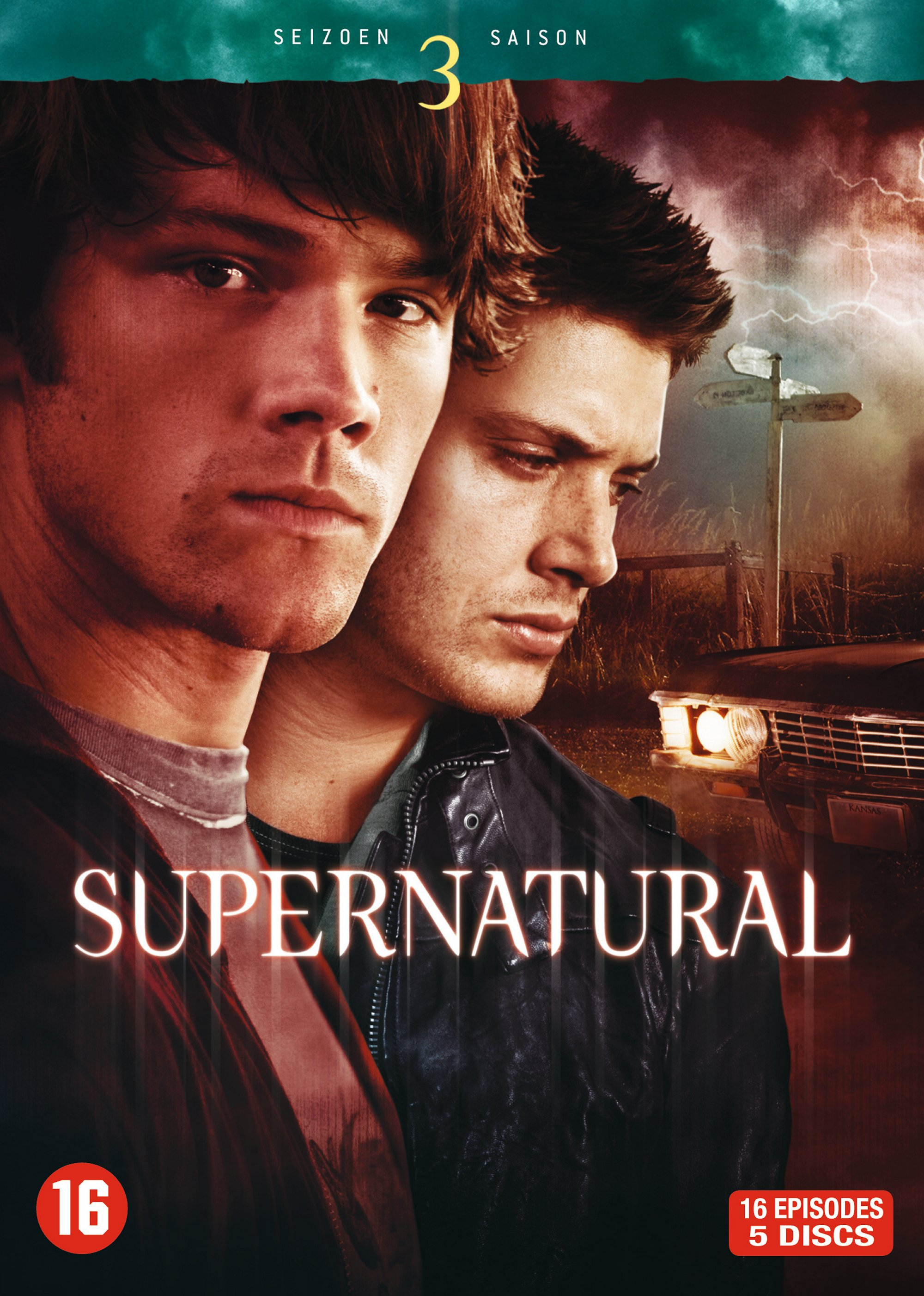 Couverture DVD avec deux hommes, le mot 'SUPERNATURAL', un panneau et des éclairs. 'SAISON 3' visible.