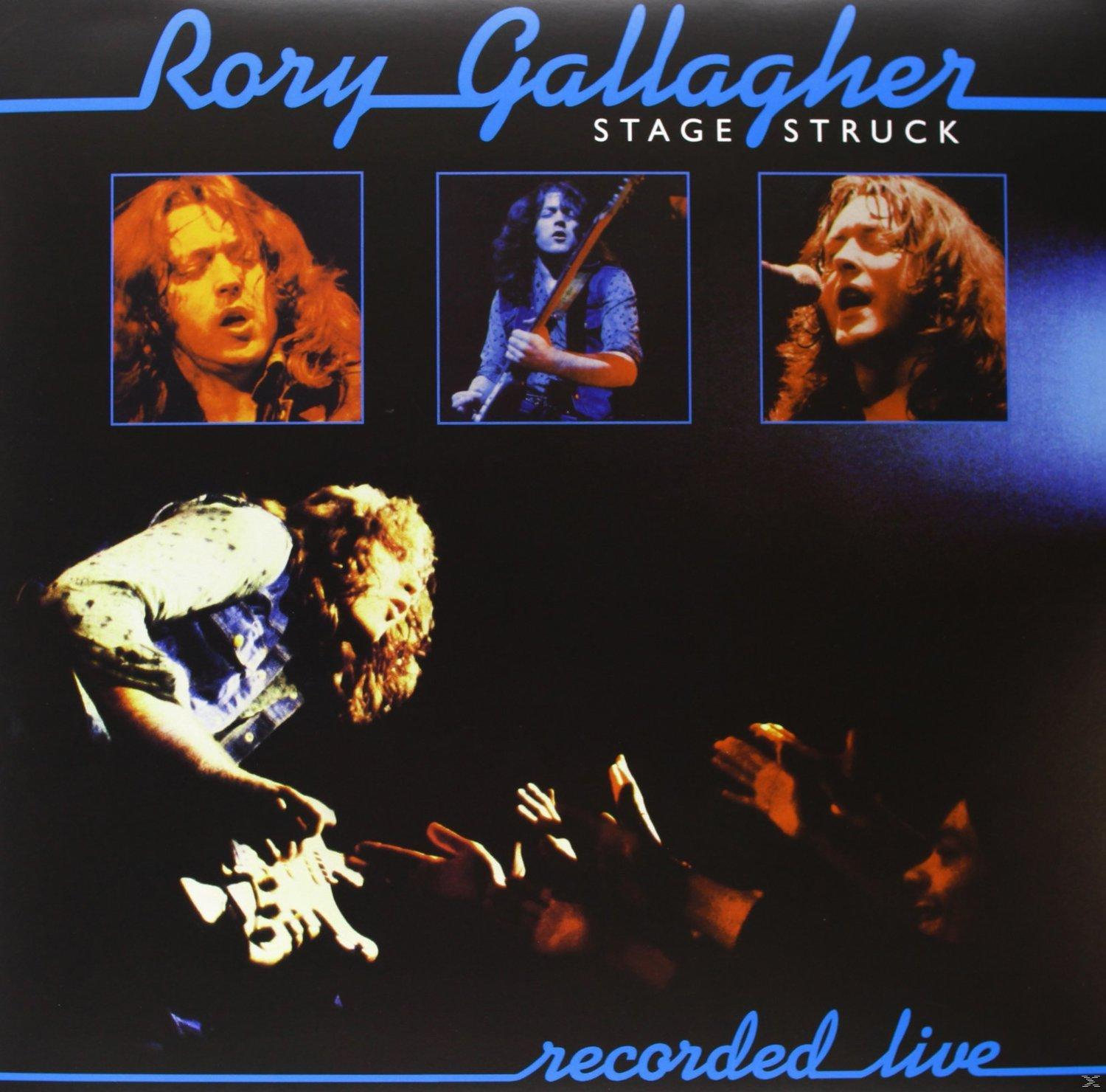 Rory Gallagher speelt gitaar, met drie portretten en de tekst "Stage Struck".