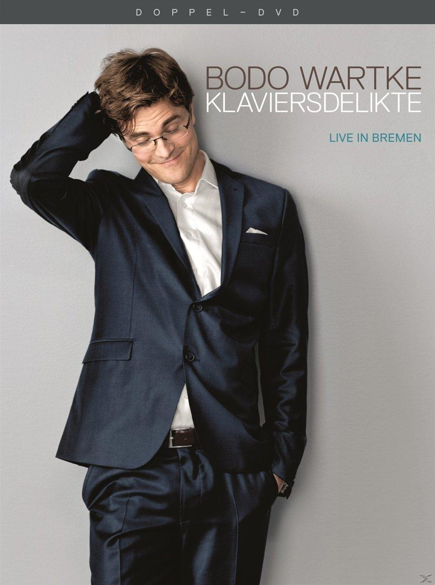 DVD-Cover mit einem Mann im Anzug, lächelnd, und dem Titel 'Bodo Wartke Klaviersdelikte', eine Live-Performance.