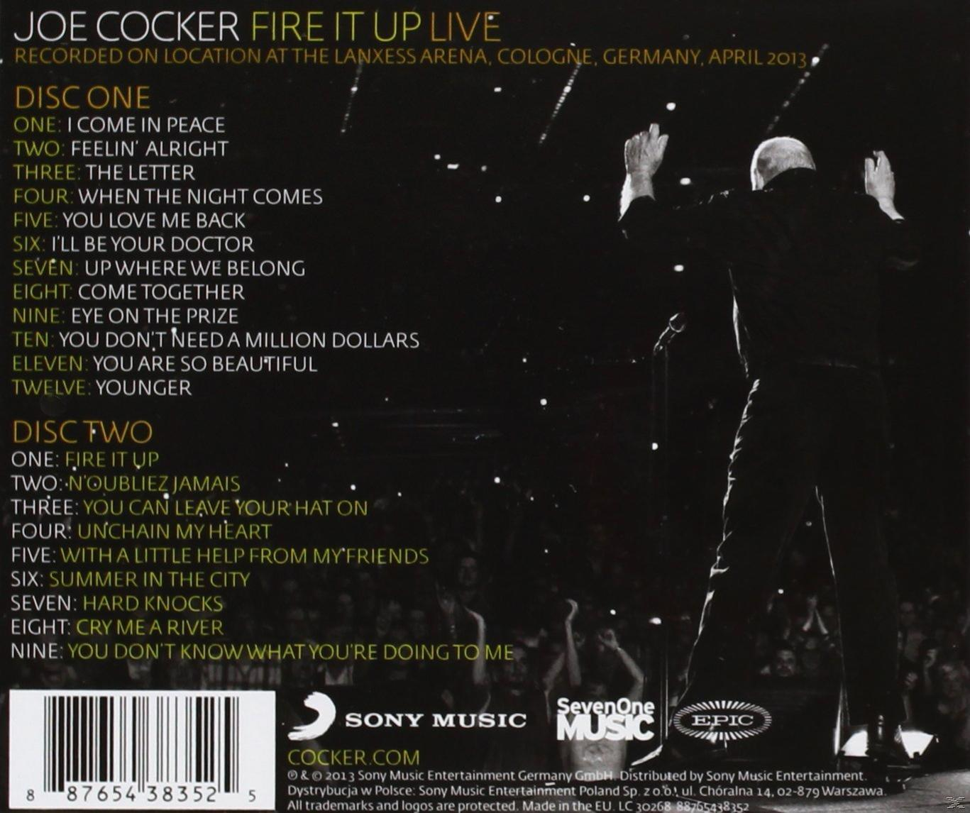 CD-Cover von Joe Cocker live in der Lanxess Arena, mit Titelliste und einem Bühnenfoto des Sängers.