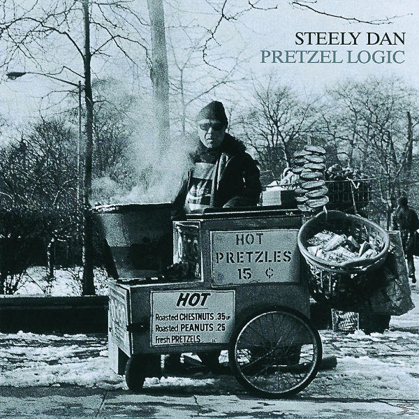 Een man verkoopt pretzels vanaf een kar. Bord zegt 'Hot Pretzels 15c'. Sneeuw op de grond.
