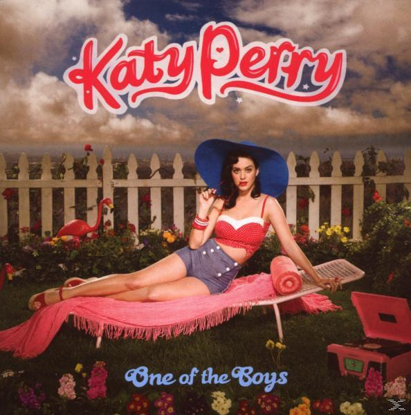Katy Perry Albumcover: Katy Perry in rotem Oberteil und blauen Shorts, liegt auf einem rosa Handtuch mit Retro-Thema.