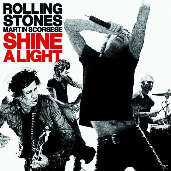 Rolling Stones 'Shine a Light' Albumcover. Bandmitglieder treten unter hellem Licht auf der Bühne auf.