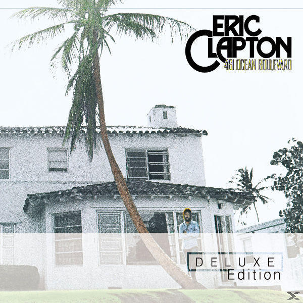 Albumcover mit Eric Clapton, einem Haus mit Palme und einem Deluxe Edition-Text.