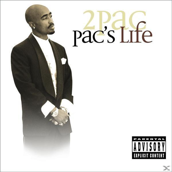 2Pac in zwart pak, wit overhemd en horloge, op witte achtergrond. Albumcover.