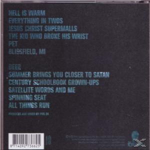 CD-Rückseite, schwarz mit hellblauem Text. Songtitel und Produktionsgutschriften sind aufgelistet.