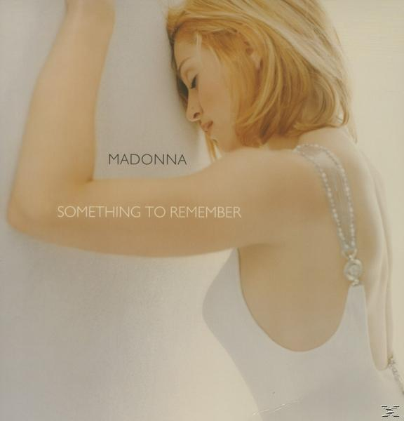 Pochette de l'album de Madonna, vue de profil, portant une robe blanche, titre 'Something to Remember'.