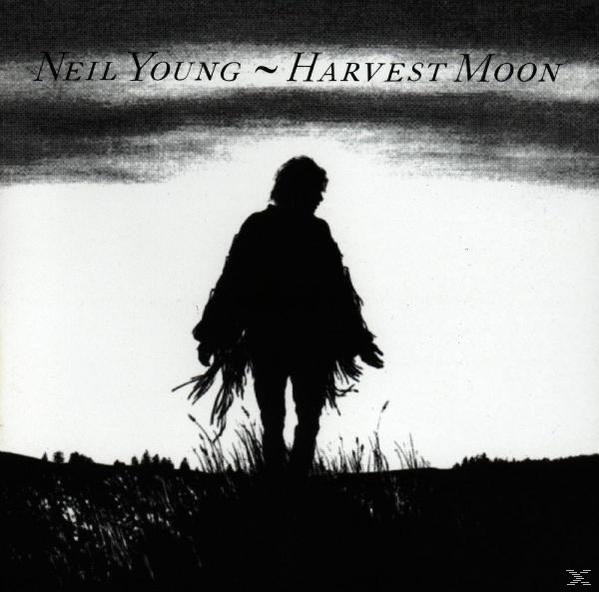 Albumcover mit einer Silhouette eines Mannes auf einem Feld und den Worten 'Harvest Moon'.