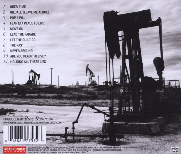 Albumcover mit Ölpumpen. Texte und ein Logo sind auf der Rückseite des Gehäuses zu sehen.