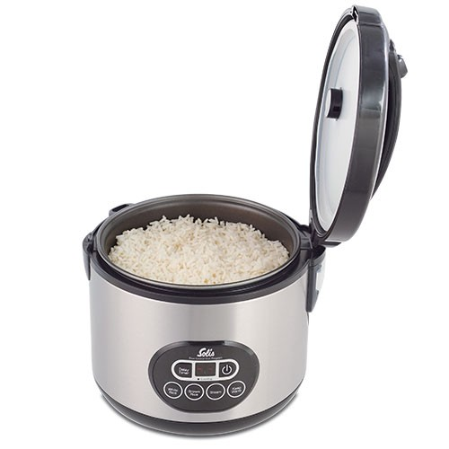 Rice cooker with lid open, full of cooked white rice. Silver body, black accents, and control panel.