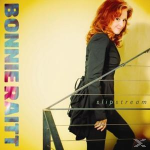 Albumcover: Bonnie Raitt, rotes Haar, blickt zurück. Gelber Hintergrund, Titel: Slipstream.
