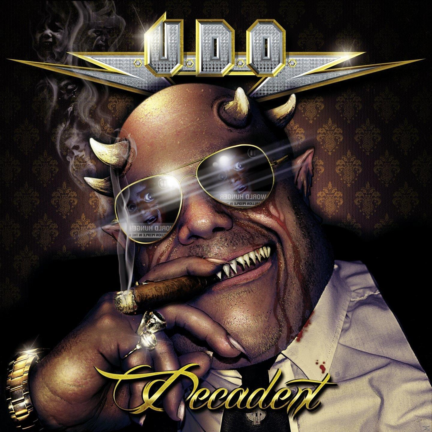 Album borító: Ördögi ember szarvakkal, szivarral, U.D.O. Decadent, arany részletek, sötét háttér.