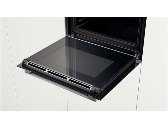 Four ouvert avec porte vitrée. L'intérieur est noir et blanc.