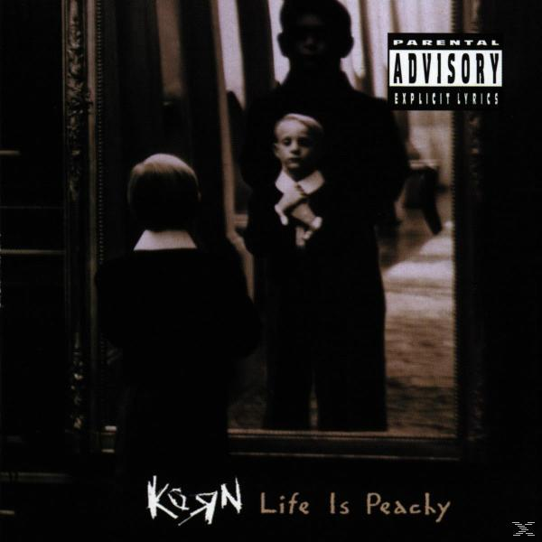 A Korn 'Life Is Peachy' albumának borítója. Egy kisfiút ábrázol egy tükör előtt, egy sötét alakkal.