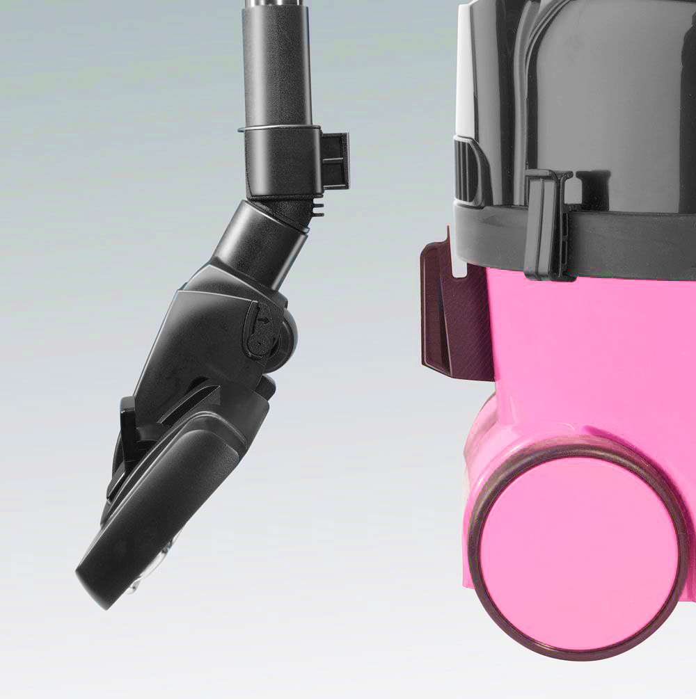 A pink vacuum cleaner with a black nozzle and handle.