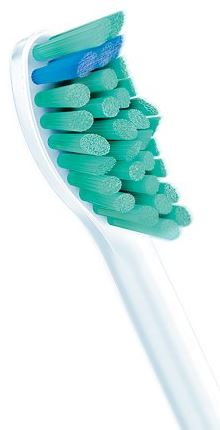 Close-up of a toothbrush head with green and blue bristles against a white background.