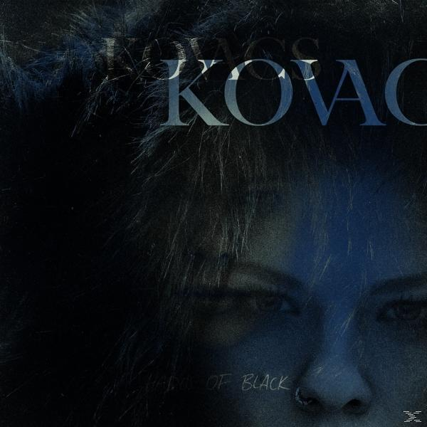 Albumcover von KOVACS, mit dem Gesicht einer Frau und den Worten: SHADES OF BLACK. Das Bild ist in dunklen Tönen gehalten.