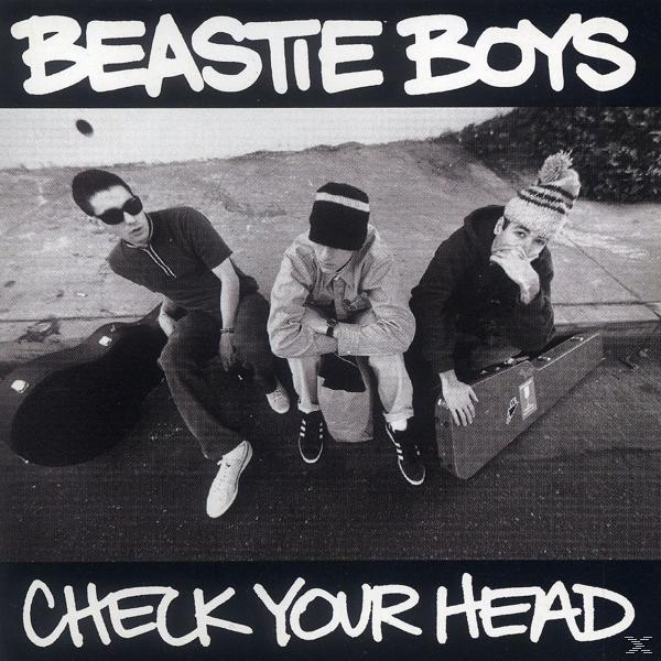 Albumcover mit drei Männern in Schwarzweiß. Der Albumtitel 'Check Your Head' steht unten.