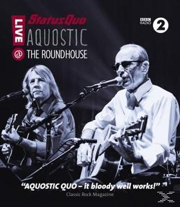 Live-Konzert mit zwei Gitarristen auf der Bühne, die Band Status Quo, mit Zitaten aus dem Classic Rock Magazine.