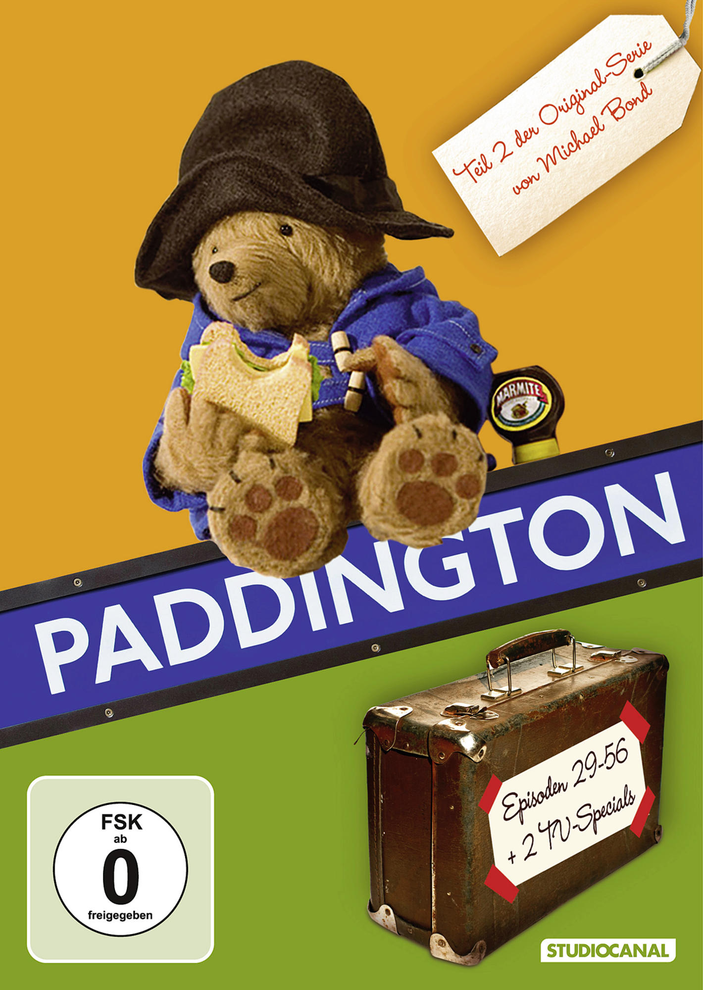 DVD-Cover von Paddington Bär mit einem Koffer. Der Bär trägt Hut und Mantel.