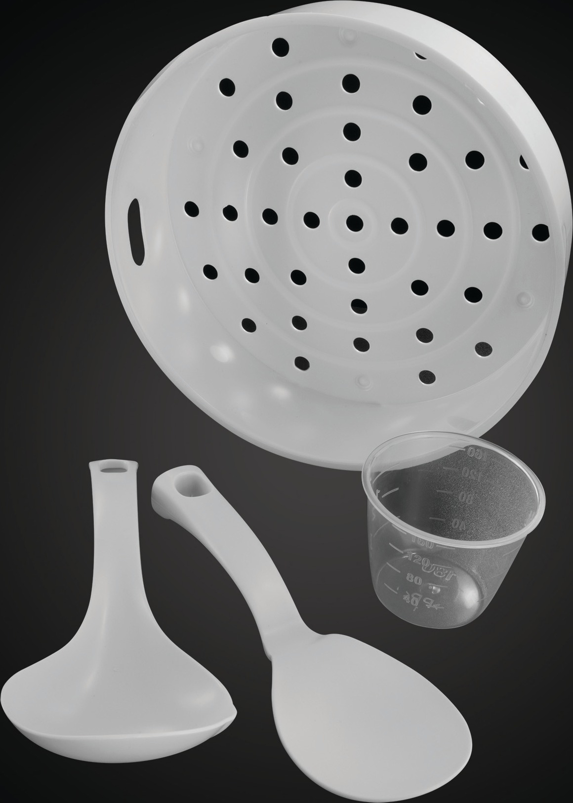 Fehér konyhai eszközök: gőzölő, mérőpohár, kanál és spatula. Mind fekete háttérrel.