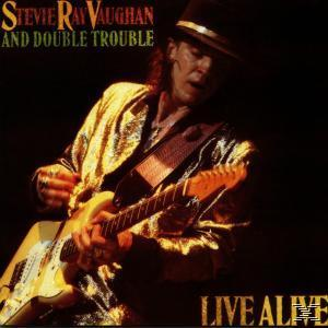 Albumcover mit einem Mann, der Gitarre spielt, eine goldene Jacke trägt, und Text.