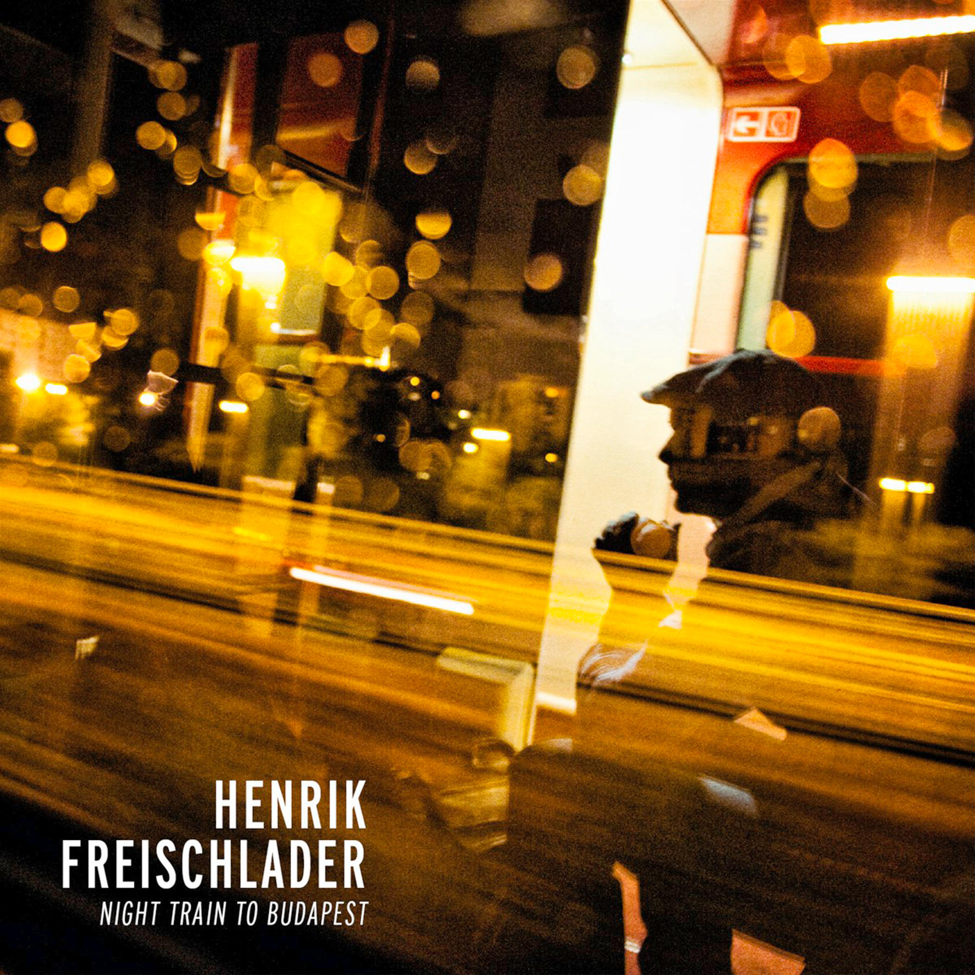 Albumcover. Eine Nachtszene, ein Zug und der Text: Henrik Freischlader, Night Train to Budapest.