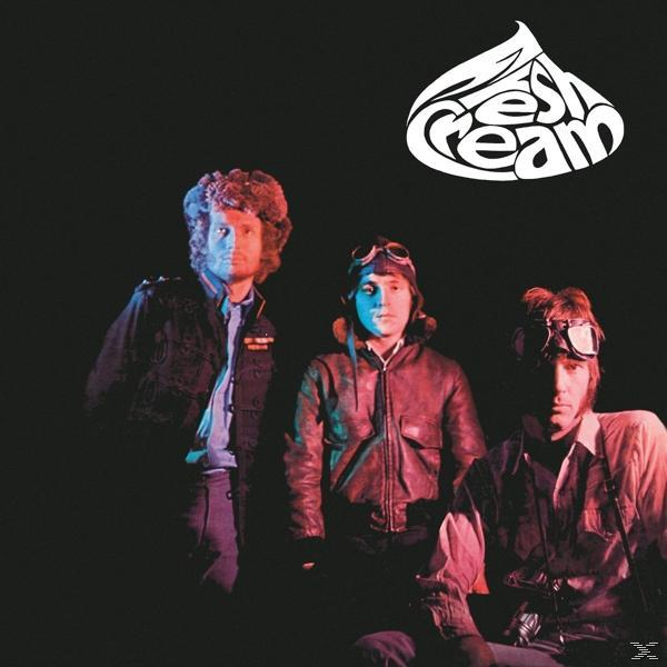 Albumcover mit drei Männern vor schwarzem Hintergrund. Der Bandname in bunter Schrift.