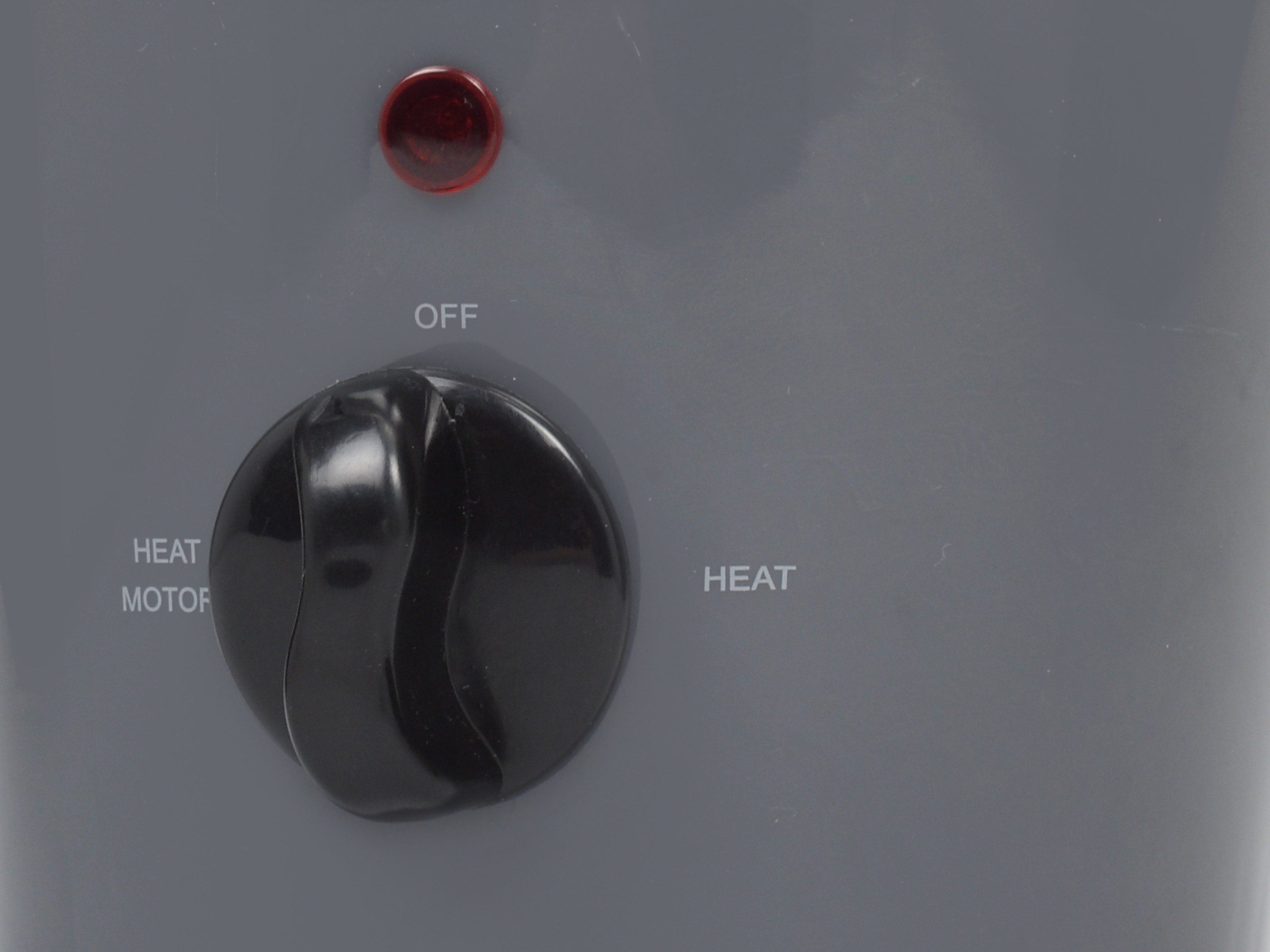 Primo piano di una manopola di controllo con impostazioni: 'OFF', 'HEAT' e 'HEAT MOTOR'.