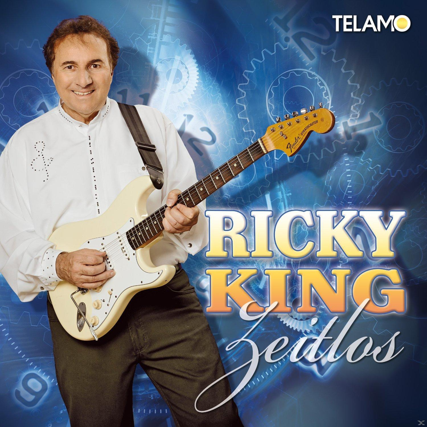 Albumcover: Ricky King mit weißer Gitarre, lächelnd, mit Titel "Zeitlos" auf blauem Hintergrund.