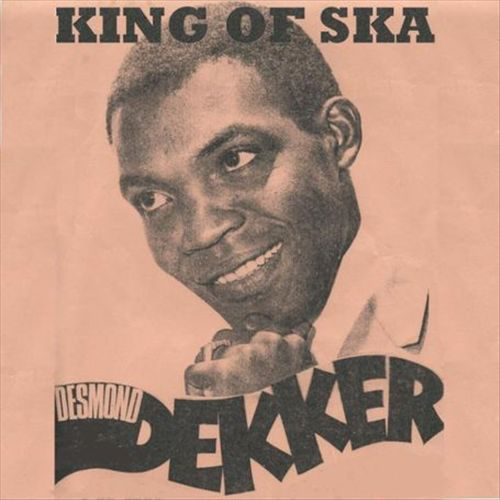Desmond Dekker album borítója. Férfi mosollyal, fehér ingben és fekete nyakkendőben. Őszibarack színű háttér.
