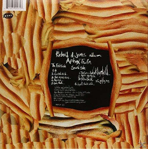 Albumcover von Aphex Twin mit handschriftlichem Text auf schwarzem Hintergrund mit Brot.