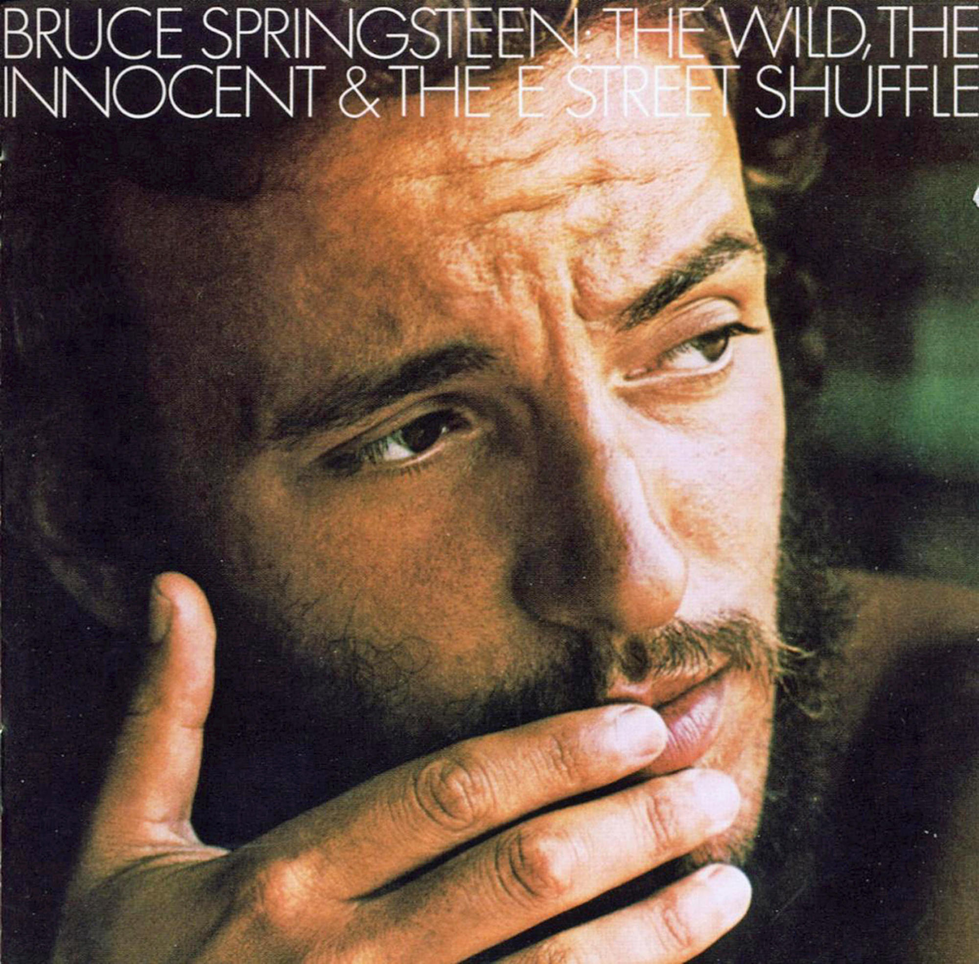 Albumcover: Bruce Springsteen. Kopfschuss mit Bart und Hand vor dem Mund. Brauntöne.