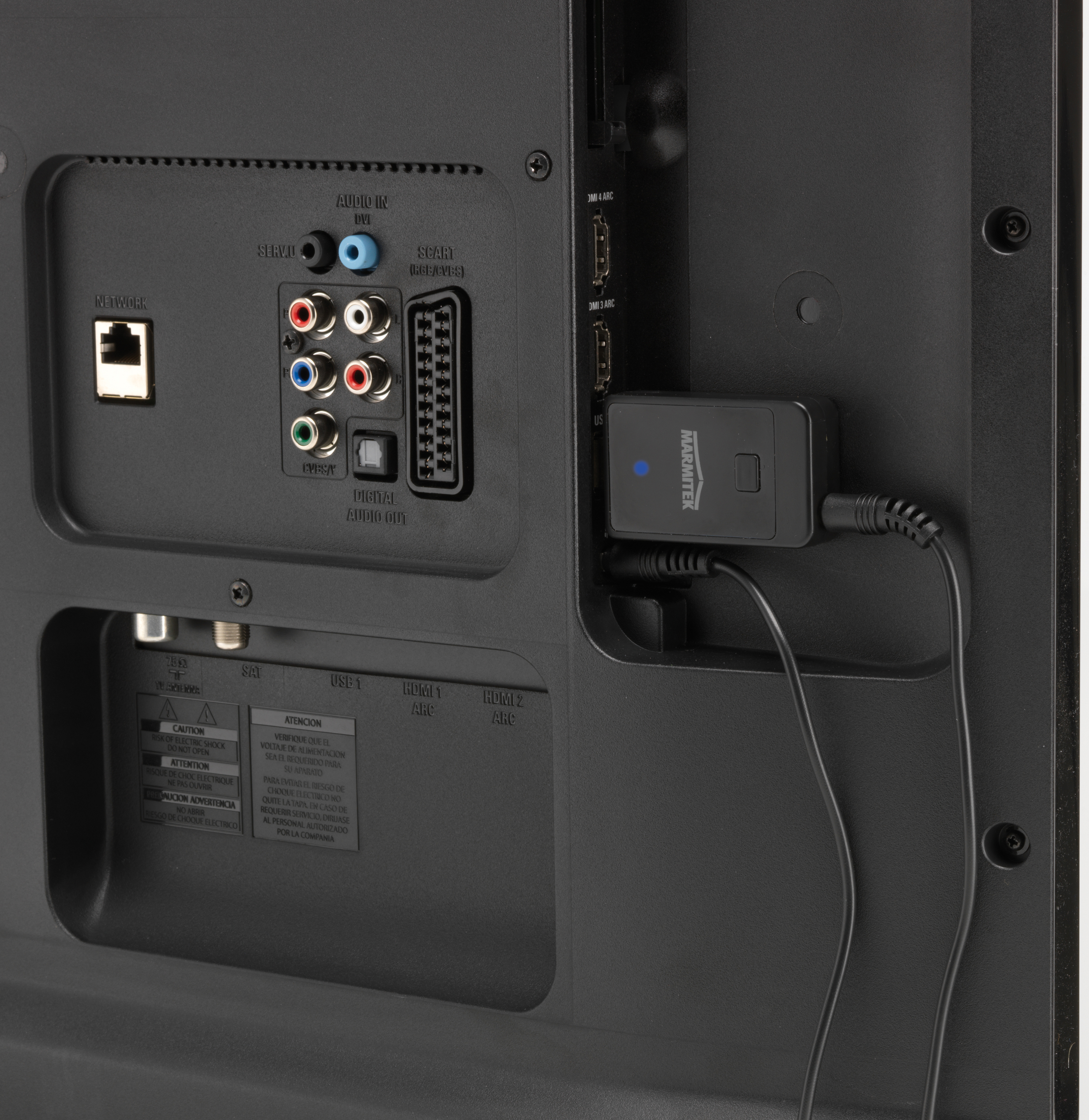 Back of a TV with ports and a black Marantek device connected. Cables plugged in, black background.