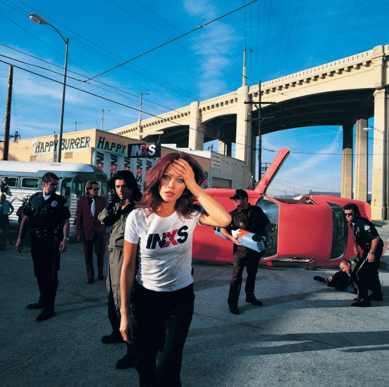 INXS Albumcover. Frau in weißem Hemd, rotes Auto, Polizisten und urbaner Hintergrund.