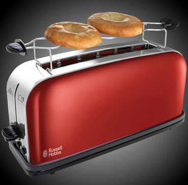 Red toaster with two bagels in it, chrome accents. The toaster is on a dark background.