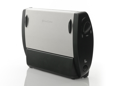 FoodSaver vacuum sealer. Gray and black device with a button on the front. White background.
