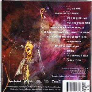 CD-Cover mit singender Frau, Text rechts. Lila und orangefarbener Hintergrund.