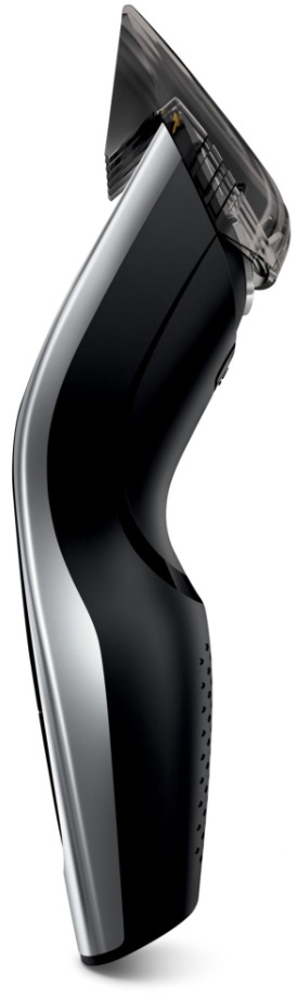 A black and silver electric hair clipper, angled to the right, with a transparent blade guard.