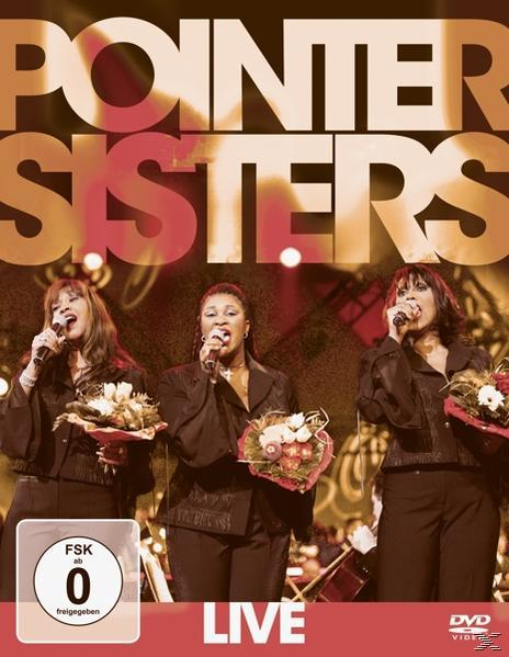 DVD-Hülle der Pointer Sisters live auf der Bühne. Drei Frauen singen in Mikrofone und halten Blumen. Roter Hintergrund.
