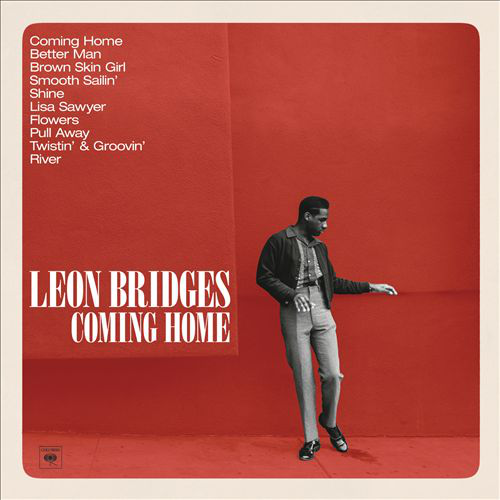 Album borítója egy férfival öltönyben, piros háttérrel. Az album címe: 'Coming Home'.